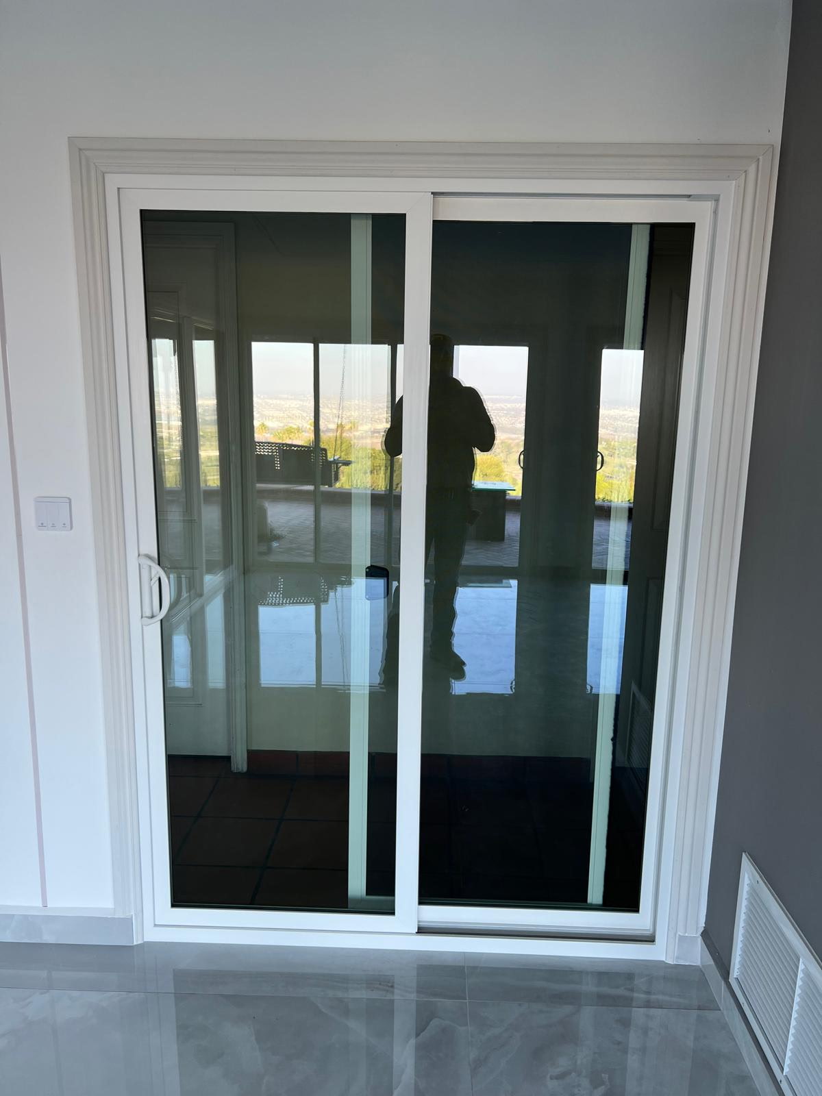 New white sliding glass patio door installation by Bright Future Homes
